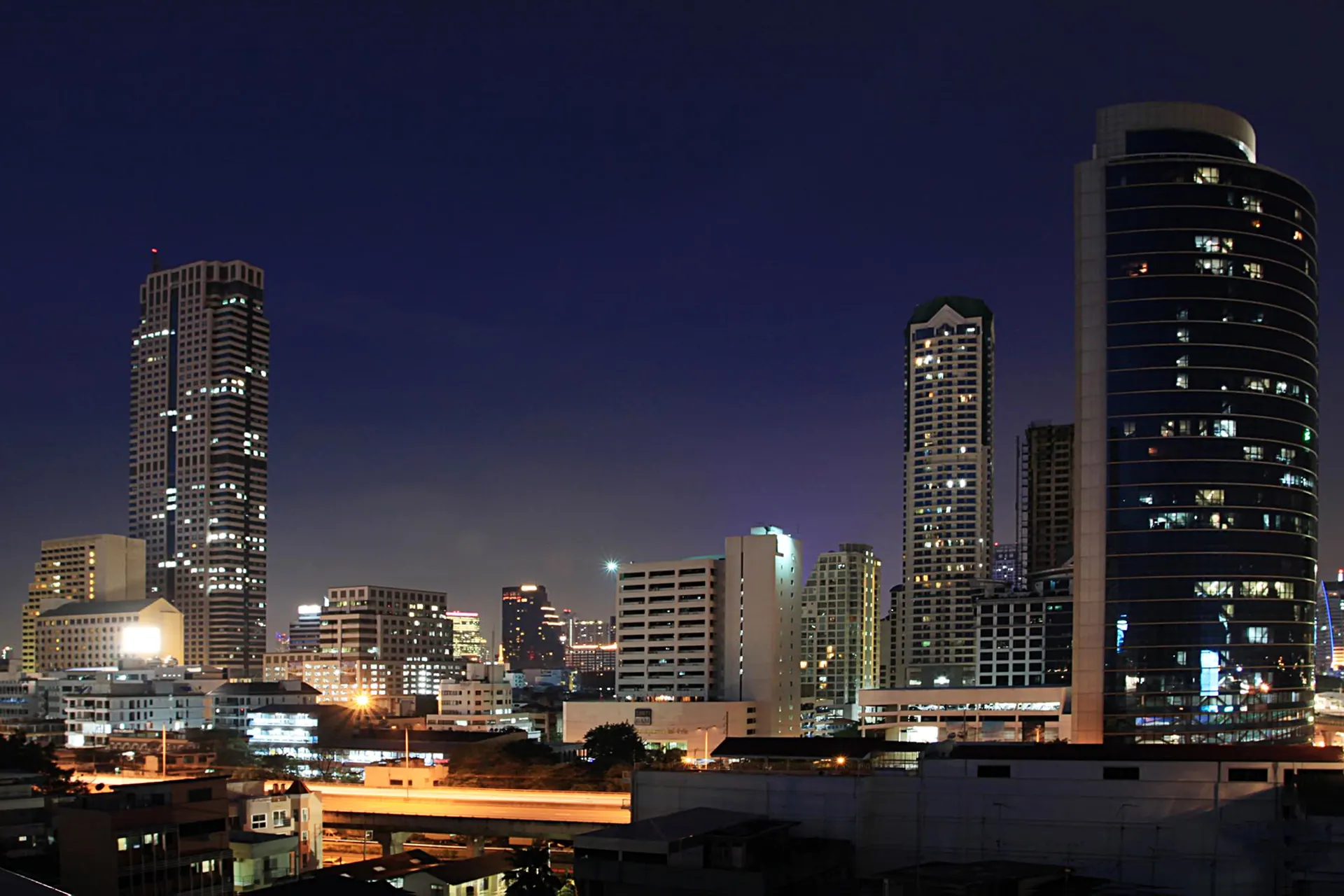 Bangkok high-rises at night, with the Jewelry Trade Center tower on the left