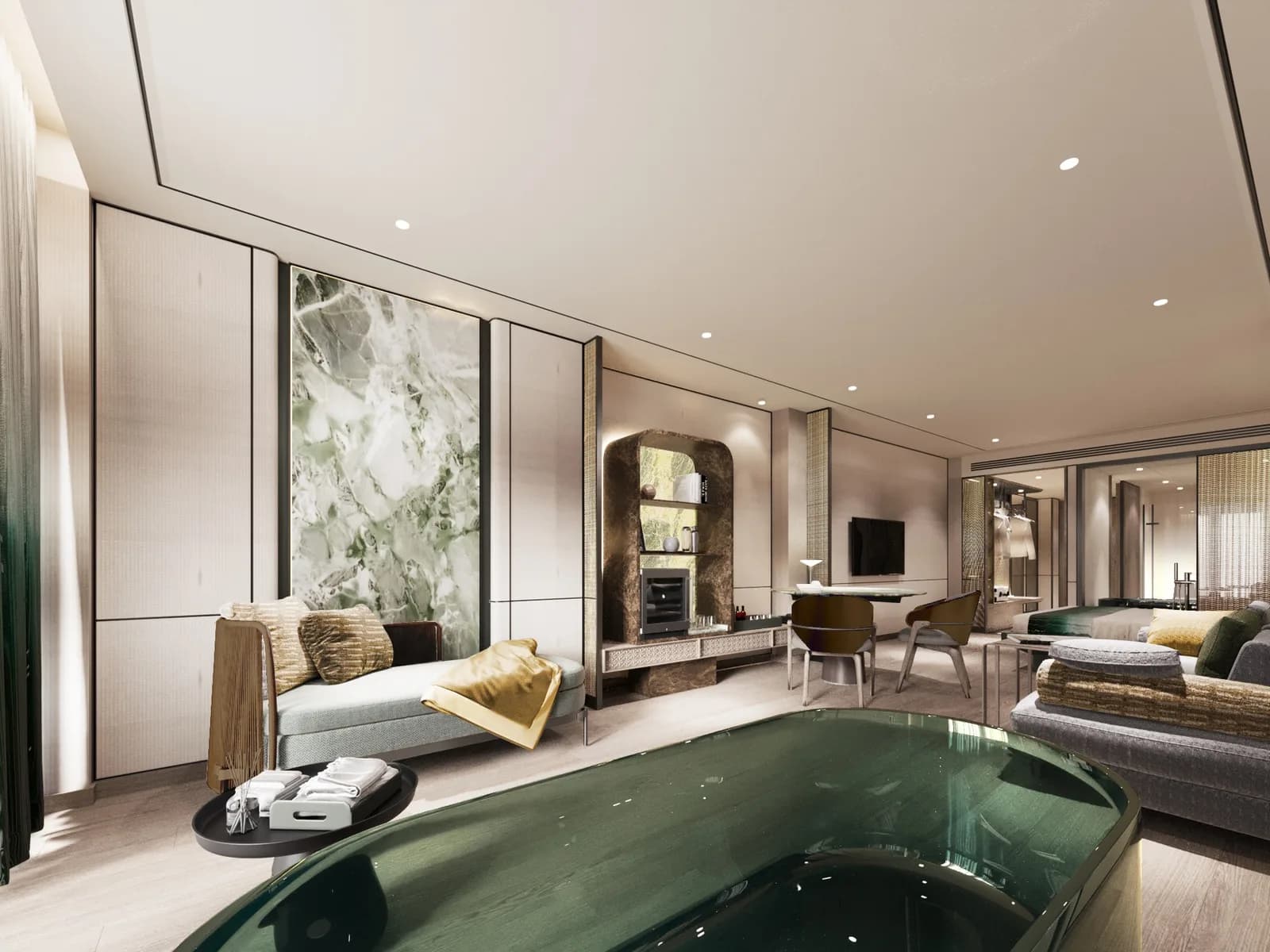 Suite interior with a freestanding green bath, sofa seating and green marble wall panels
